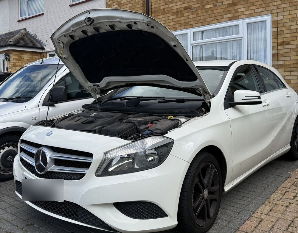 White Mercedes with the bonnet open on a customer's driveway during a mobile service